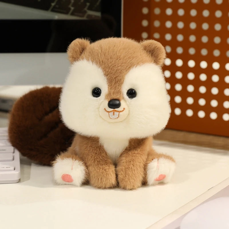 Plush kawaii toy resembling a fox with brown and white fur on a desk.