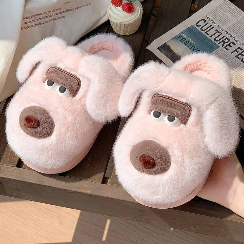 Pink bear-shaped kawaii slippers on a wooden surface with a newspaper and small cake in the background.