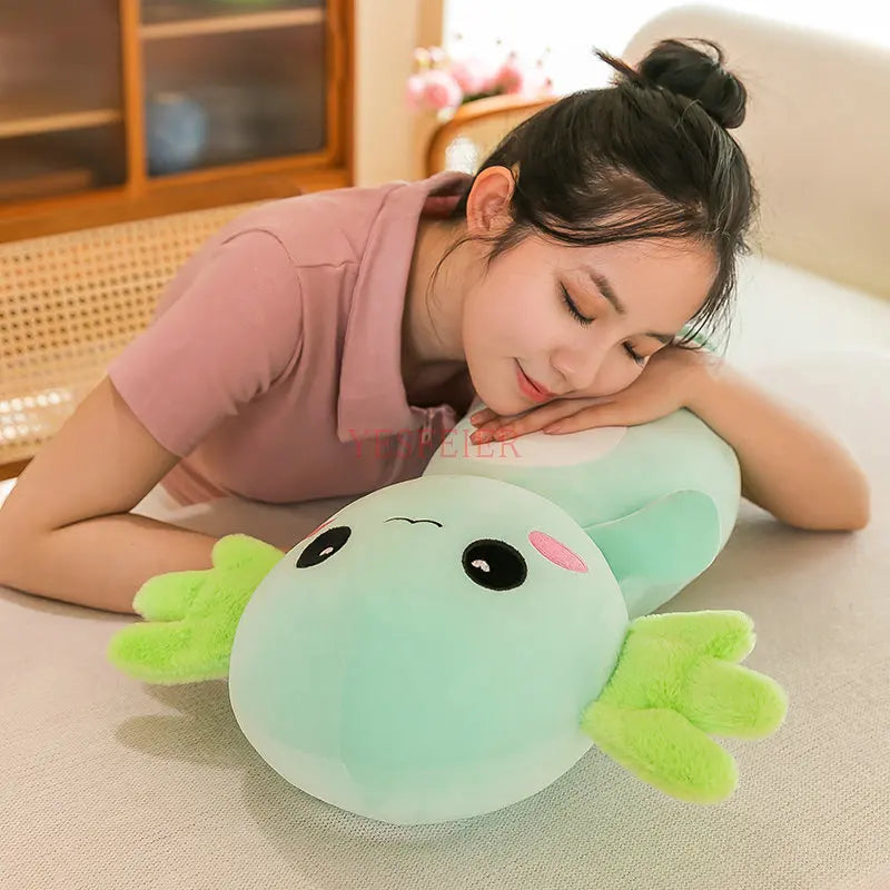 Woman lying on a couch with a green frog-shaped kawaii pillow