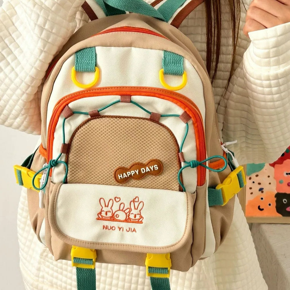 Children's Kawaii backpack with colorful straps held by a person wearing a white coat.