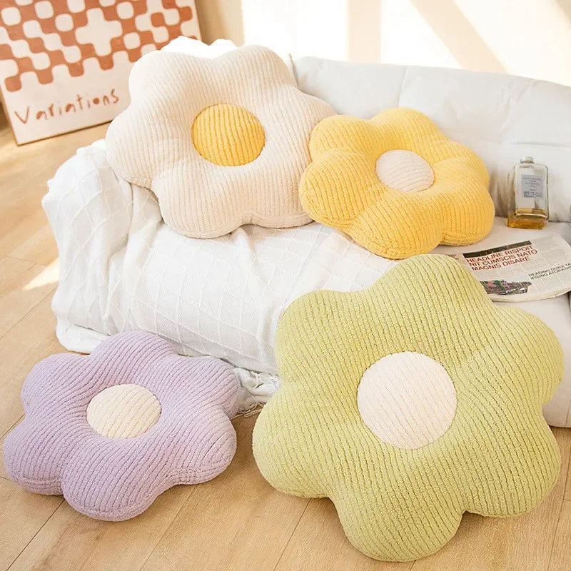 Flower-shaped kawaii cushions in various colors on a wooden floor.