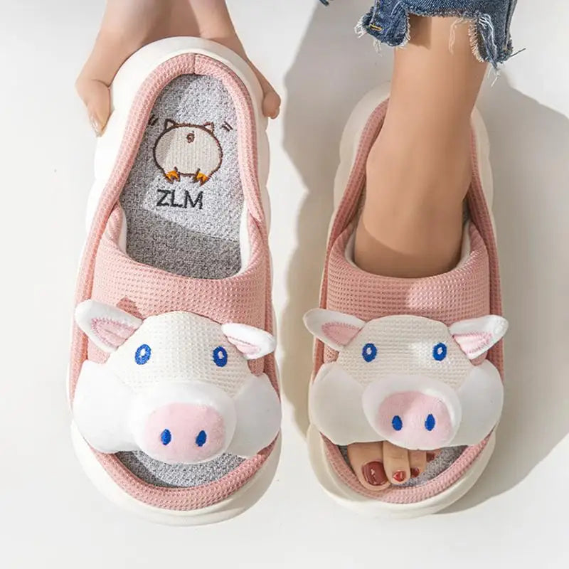 Pink kawaii cartoon cow slippers worn by a person on a white background