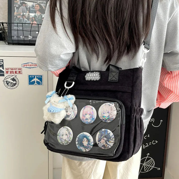 Person wearing a black Kawaii bag with character pins and a plush toy, standing in front of a whiteboard.