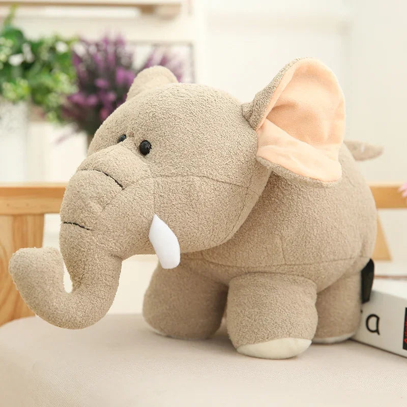 Kawaii plush elephant toy on a light surface with a blurred background