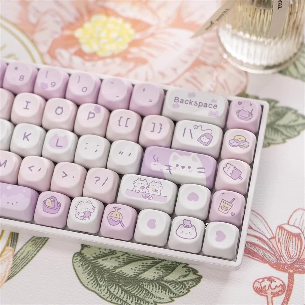 Set of cute keycaps with Kawaii cartoon designs on a decorative surface