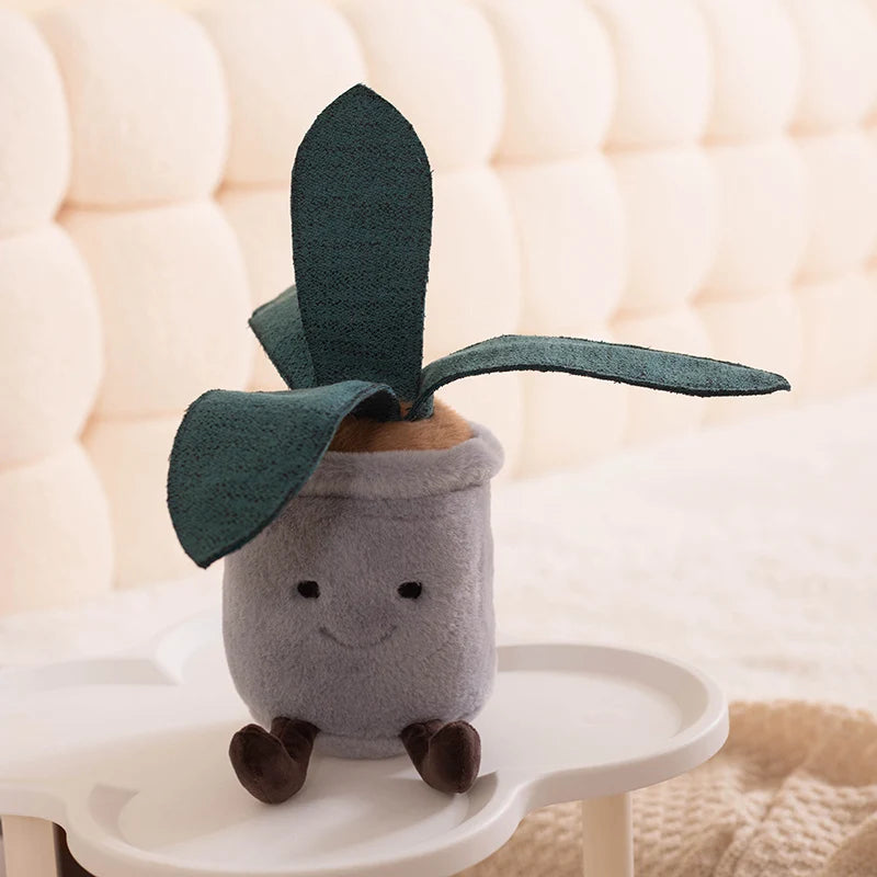 Plush kawaii toy shaped like a potted plant with green leaves on a white surface.