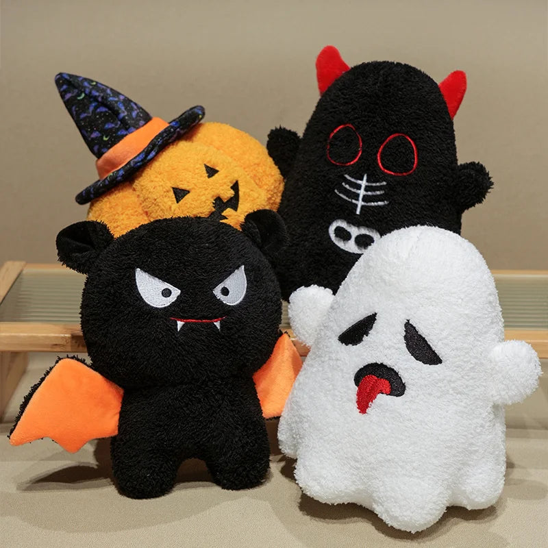 Three Halloween-themed plush kawaii toys: a black cat, a white ghost, and a pumpkin with a witch hat.