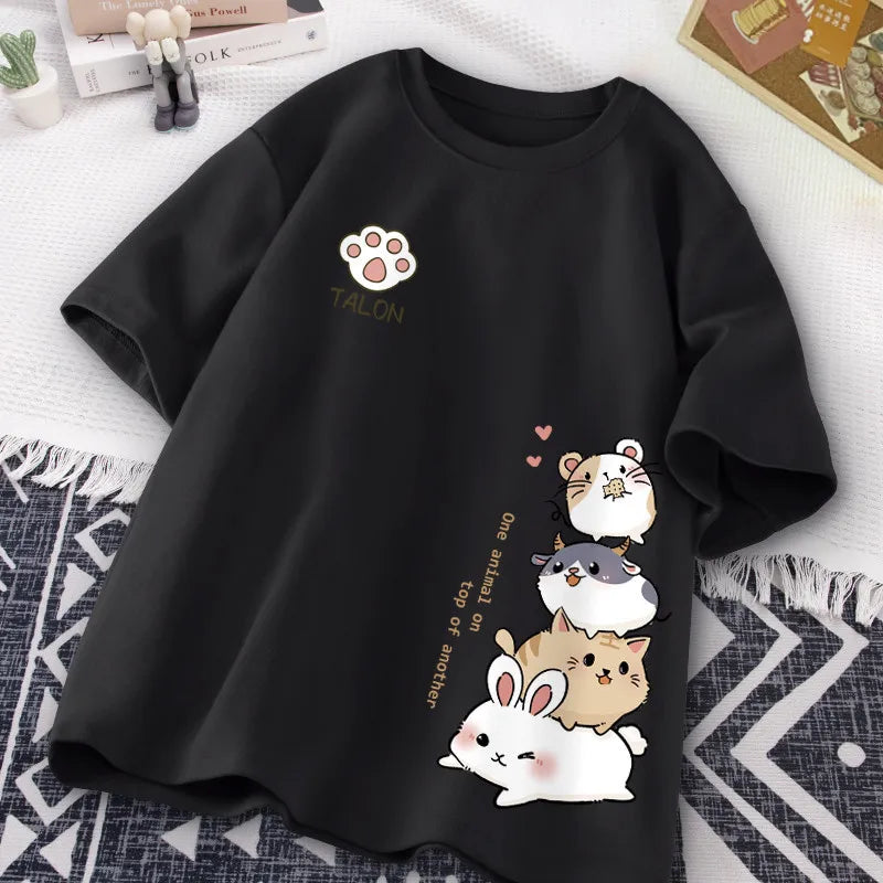 Black t-shirt with kawaii cartoon animals and text on a white surface