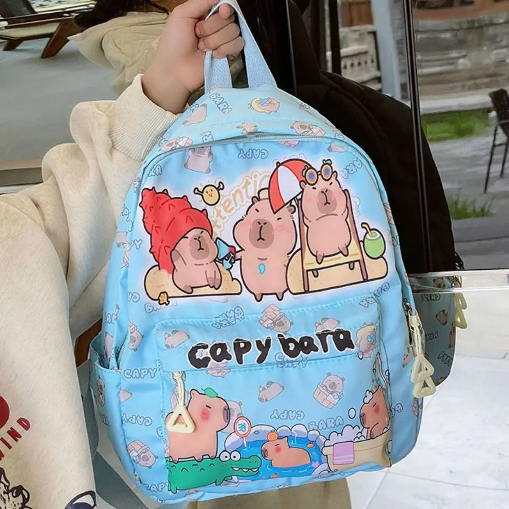 Light blue Kawaii backpack with cartoon characters on a person's arm