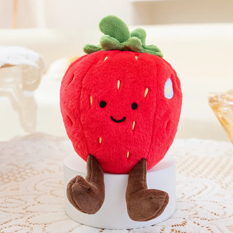 Kawaii plush strawberry toy with a smiling face on a white surface