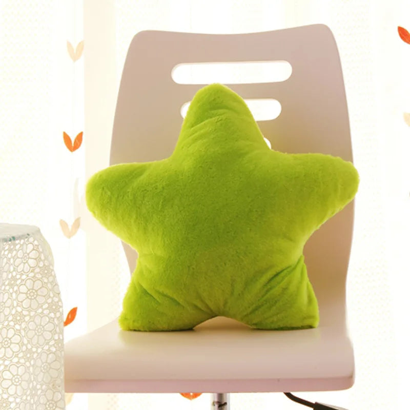 Green star-shaped Kawaii pillow on a white chair with a blurred background