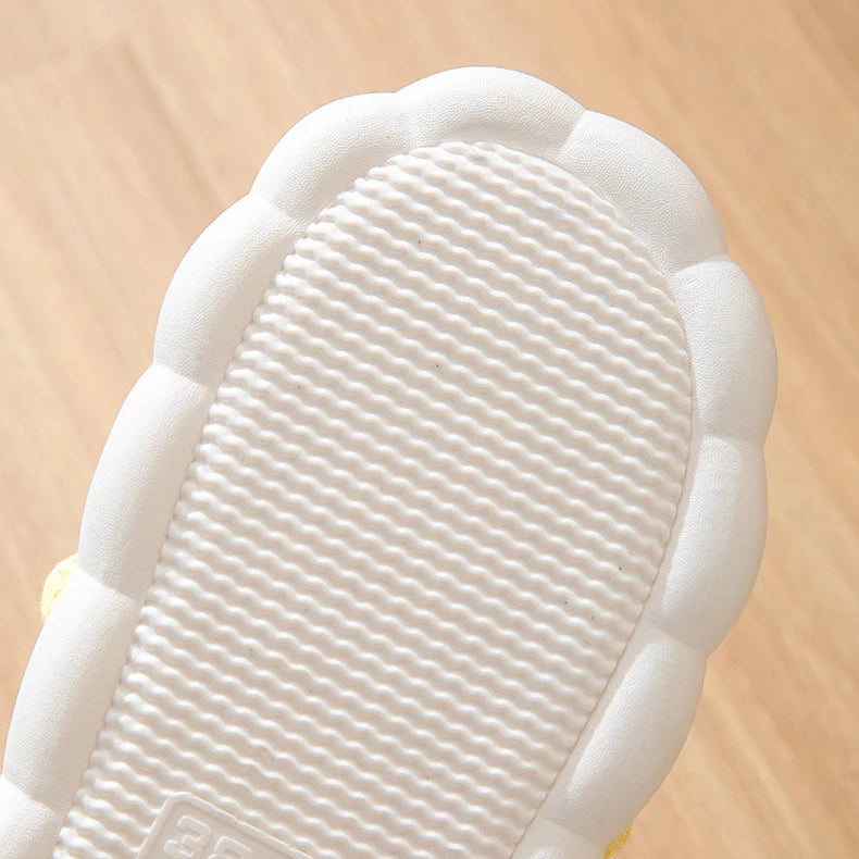 Close-up of a white kawaii-style shoe on a wooden surface
