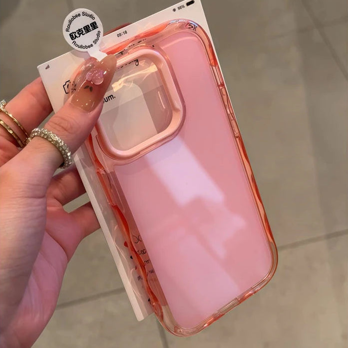 Pink kawaii phone case with clear back held by a hand on a neutral background