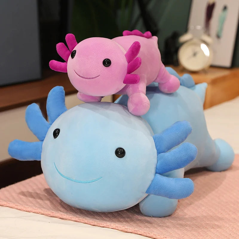 Pink and blue plush kawaii toys on a pink blanket with a blurred background
