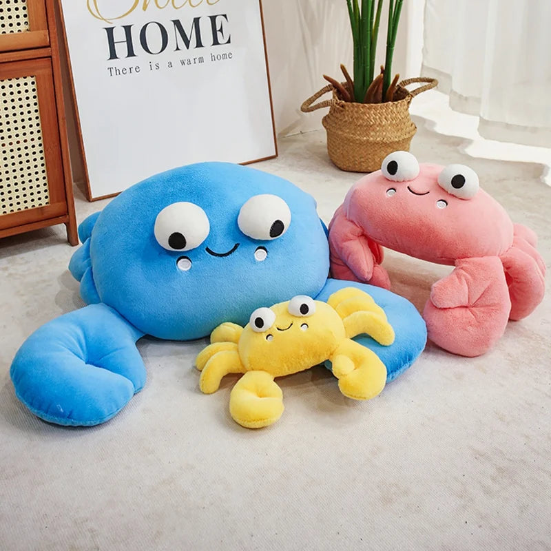 Three colorful crab-shaped kawaii plush toys on a light-colored floor.