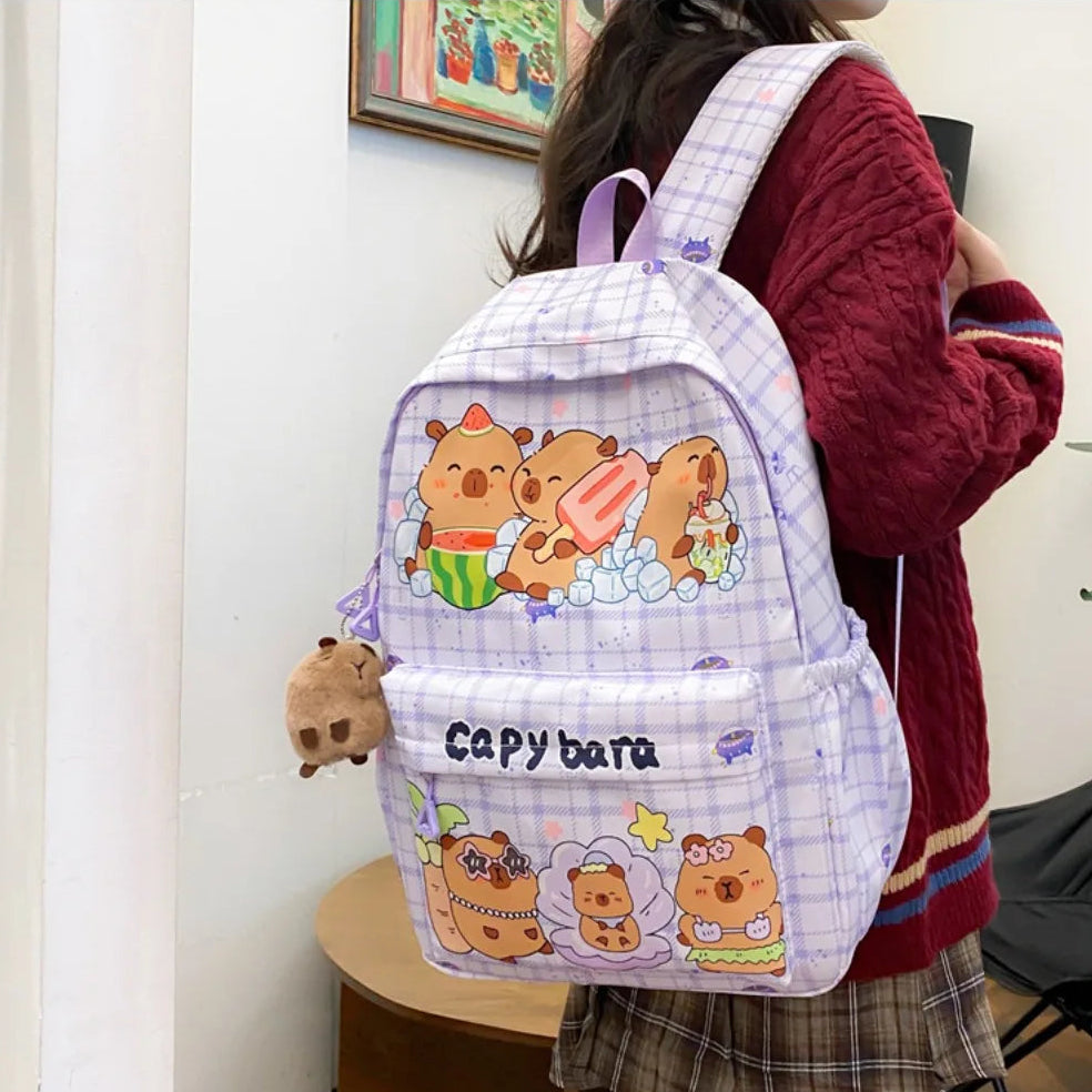Person wearing a backpack with Kawaii cartoon bear designs and 'Capybara' text.