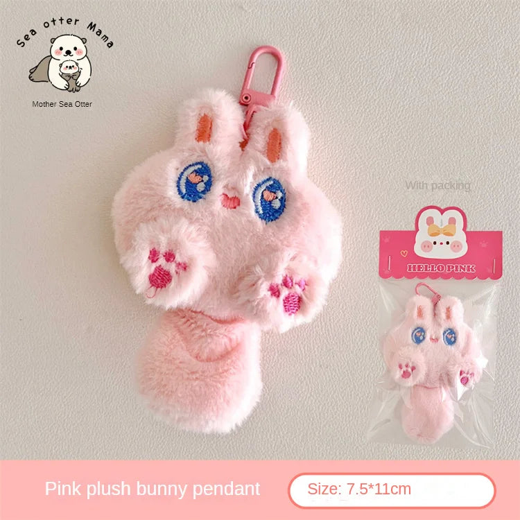 Pink kawaii plush bunny pendant with packaging on a light gray background