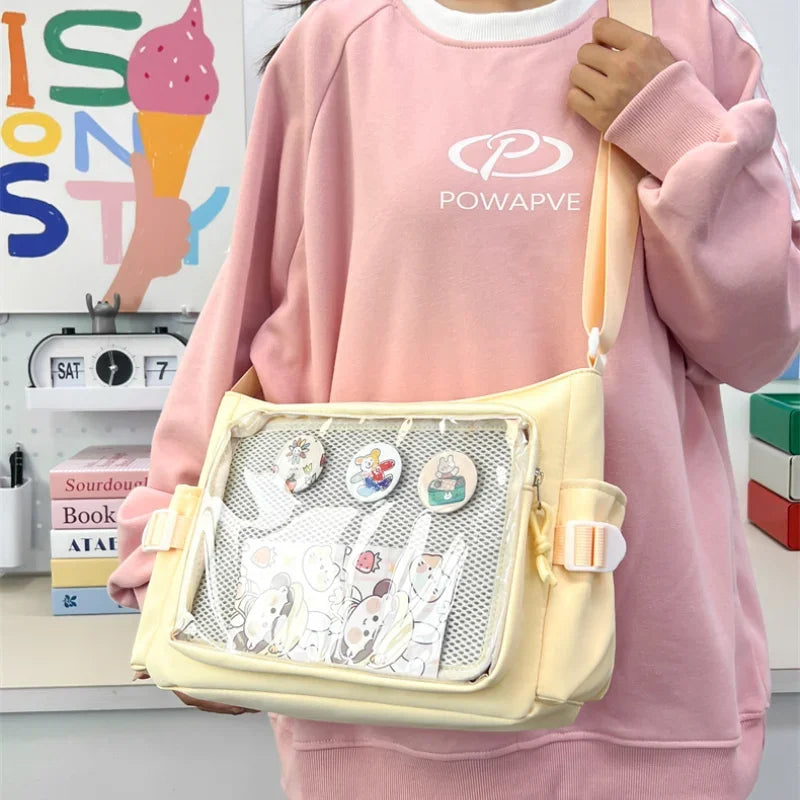 Person wearing a pink sweatshirt with 'POWAPVE' logo, holding a yellow Kawaii crossbody bag with visible branding.