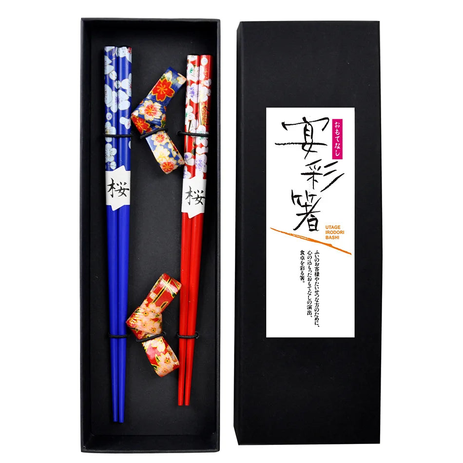 Set of blue and red kawaii chopsticks with decorative cases in a black box packaging.
