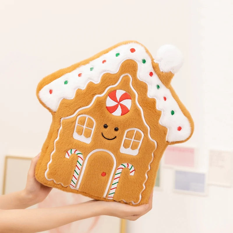 Gingerbread house-shaped kawaii plush toy held by a hand on a light background
