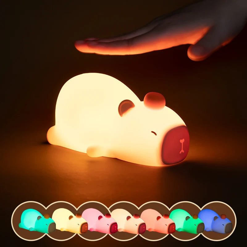White kawaii capybara night light with multicolor options on a dark background