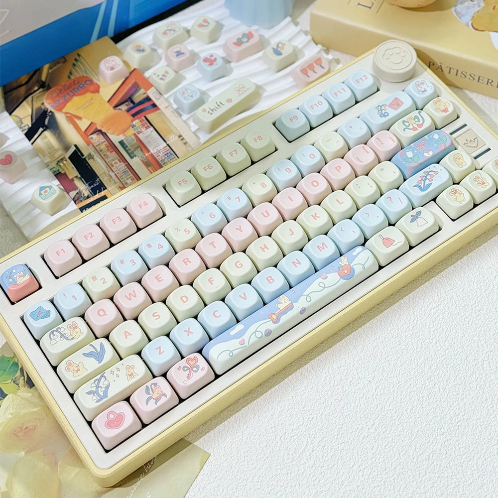 Keyboard with pastel-colored Kawaii keys in a box on a white surface