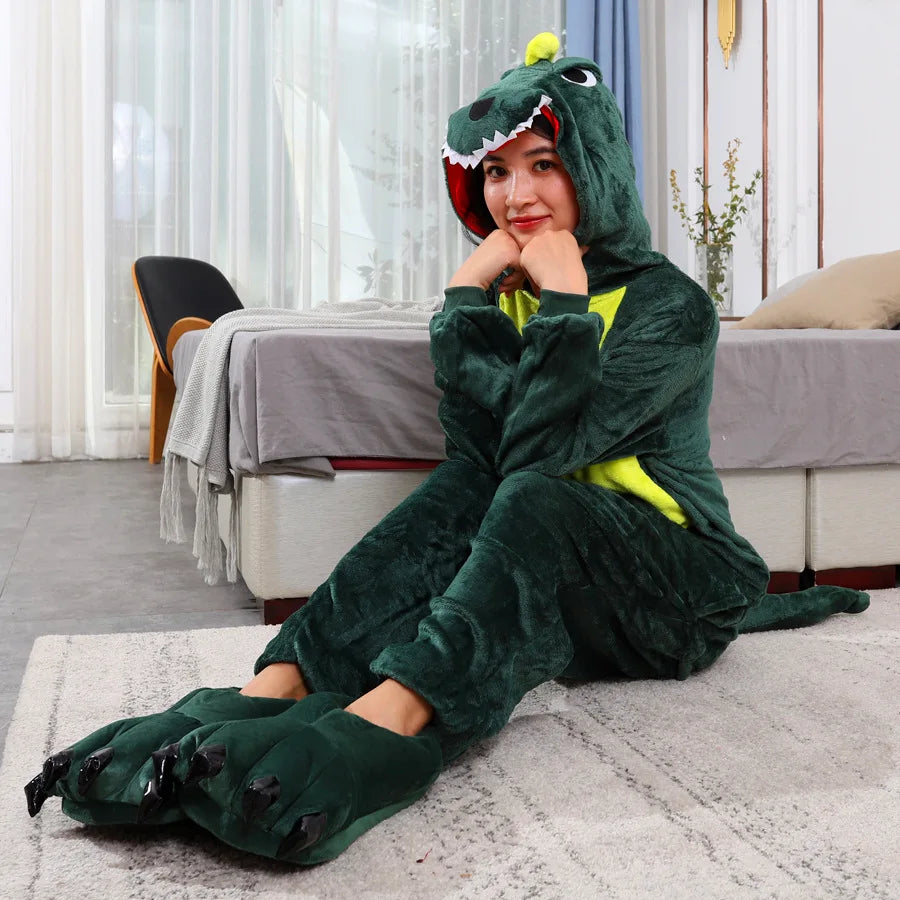 Person wearing a green kawaii dinosaur onesie sitting on the floor in a room.