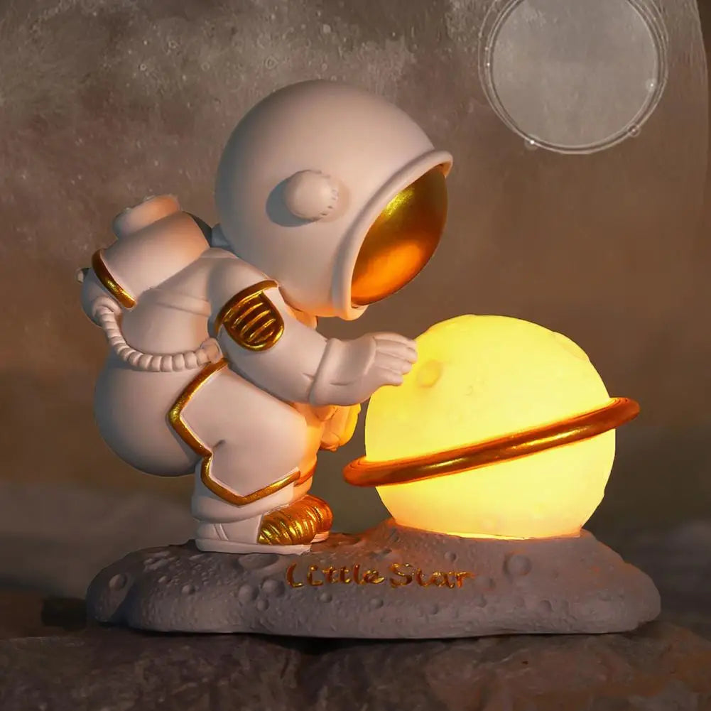 Decorative kawaii figurine of an astronaut holding a glowing sphere with a moon in the background