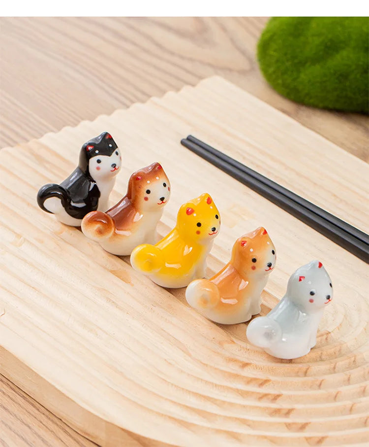 Set of small kawaii animal figurines on a wooden surface with chopsticks.