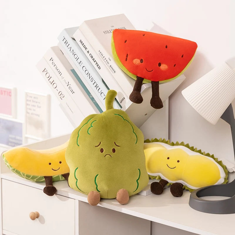 Plush kawaii toys resembling a caterpillar, banana, and watermelon on books