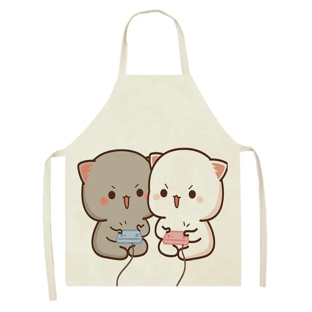 Beige apron with cartoon Kawaii cat designs holding a cassette and phone on a white background