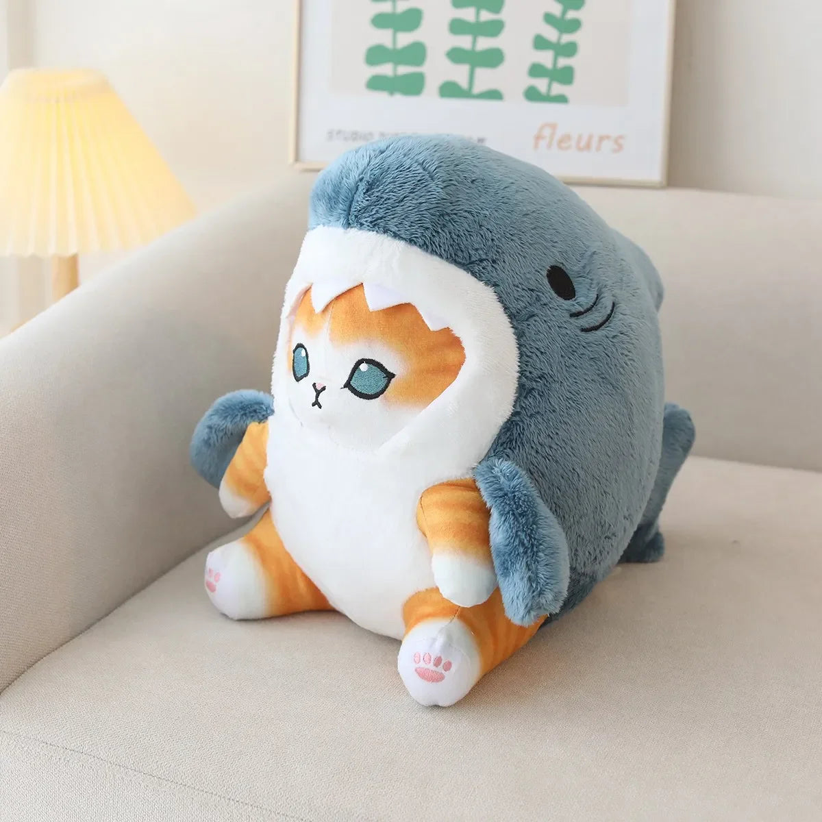 Plush kawaii toy with cat and shark design on a couch