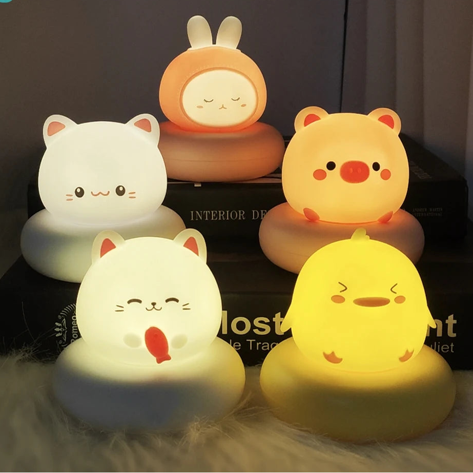 Set of kawaii cartoon animal night lights on a dark surface
