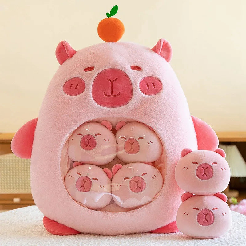 Pink kawaii plush toy shaped like a pig with smaller pig plushies inside, on a light background.