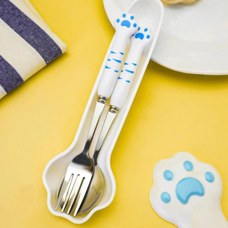 Children's cutlery set with kawaii paw print design on a yellow background