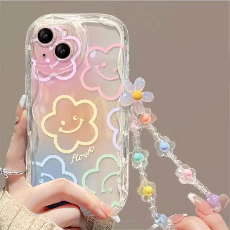 Clear phone case with floral kawaii designs and a strap held by a person.