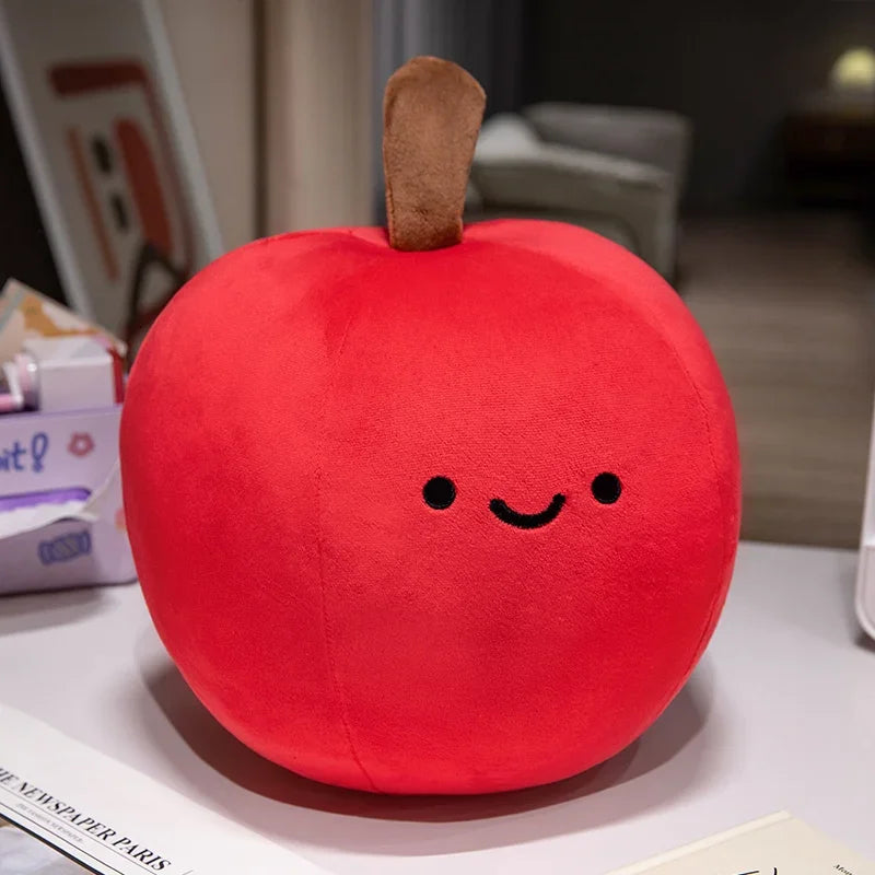 Plush kawaii toy shaped like a red apple with a smiley face on a surface.