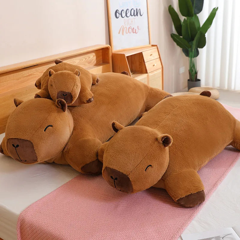Four brown hippo-shaped kawaii pillows on a bed with a plant and wooden dresser in the background.