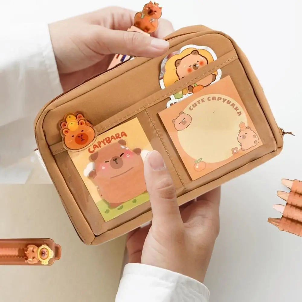 Small brown leather wallet with kawaii cartoon character design held by a person.