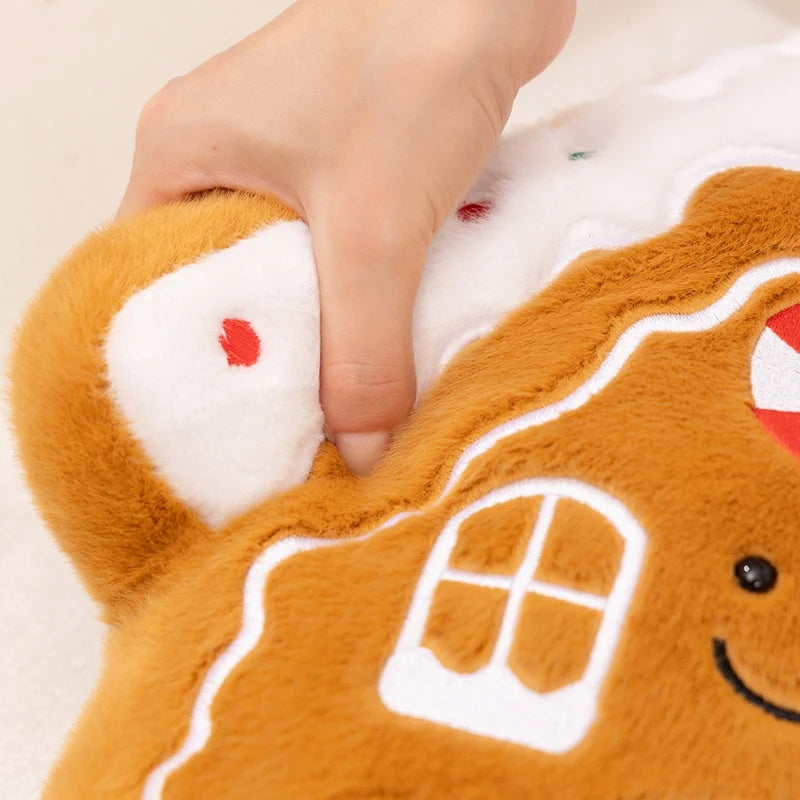 Close-up of a gingerbread man kawaii plush toy with a hand holding it.