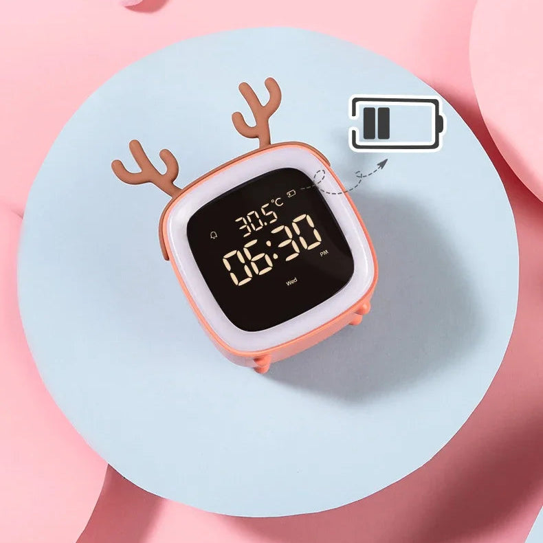 Kawaii digital clock with deer antlers on a pink background