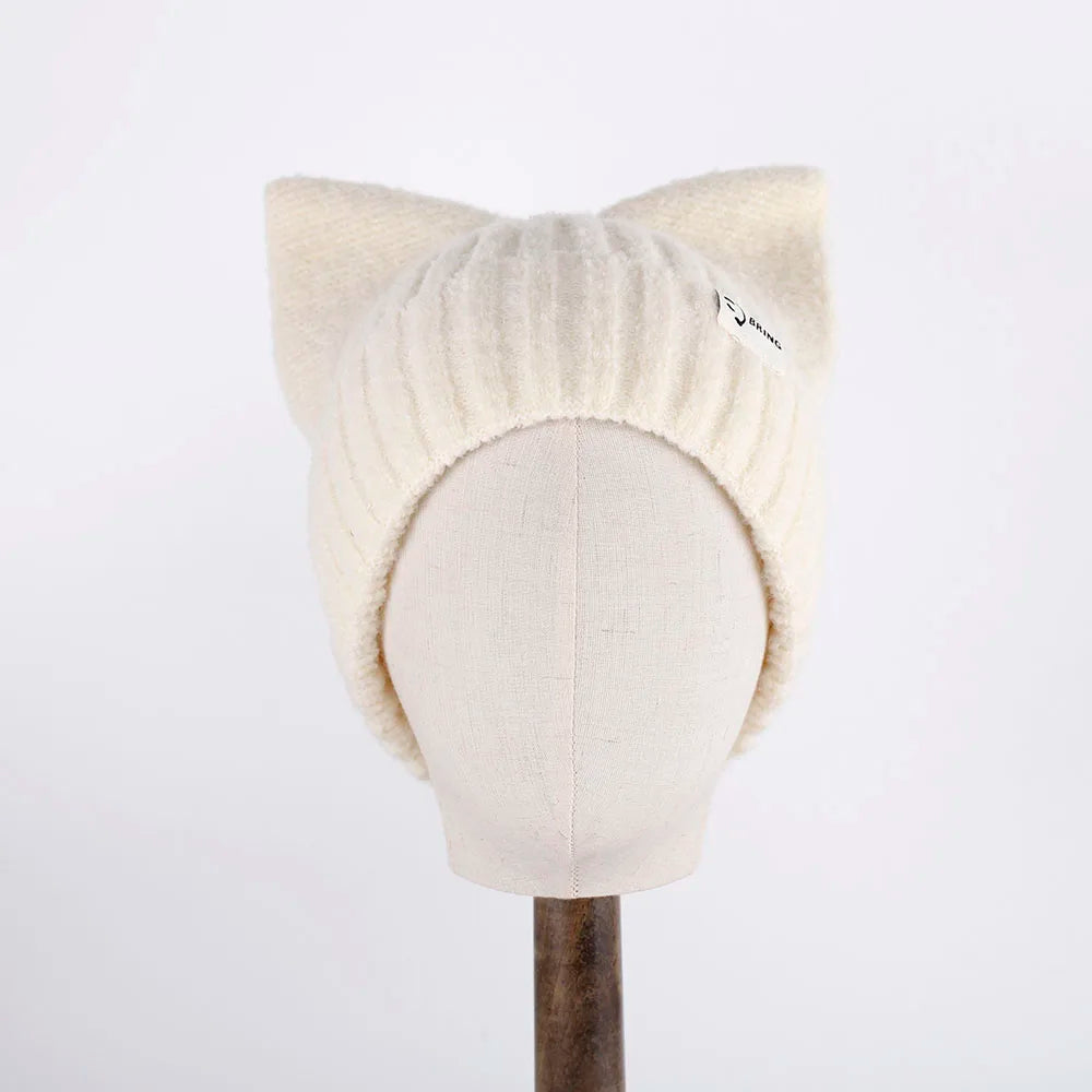 White knitted cat ear Kawaii hat on a mannequin head against a white background