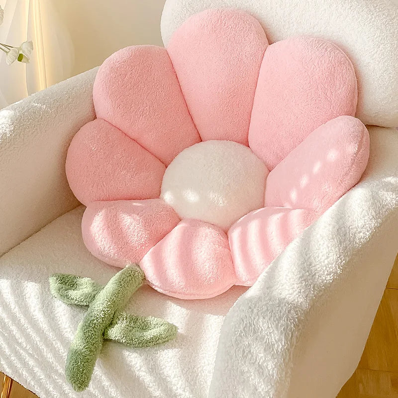 Pink flower-shaped Kawaii cushion with a white center on a soft surface