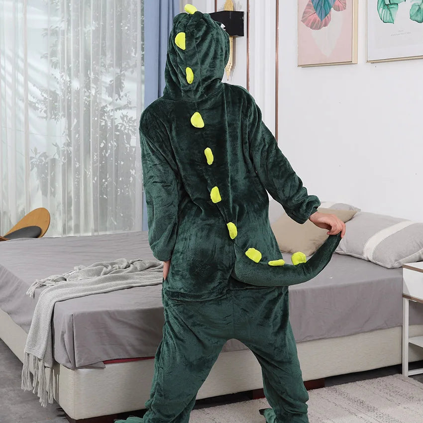 Person wearing a green kawaii dinosaur onesie in a bedroom.