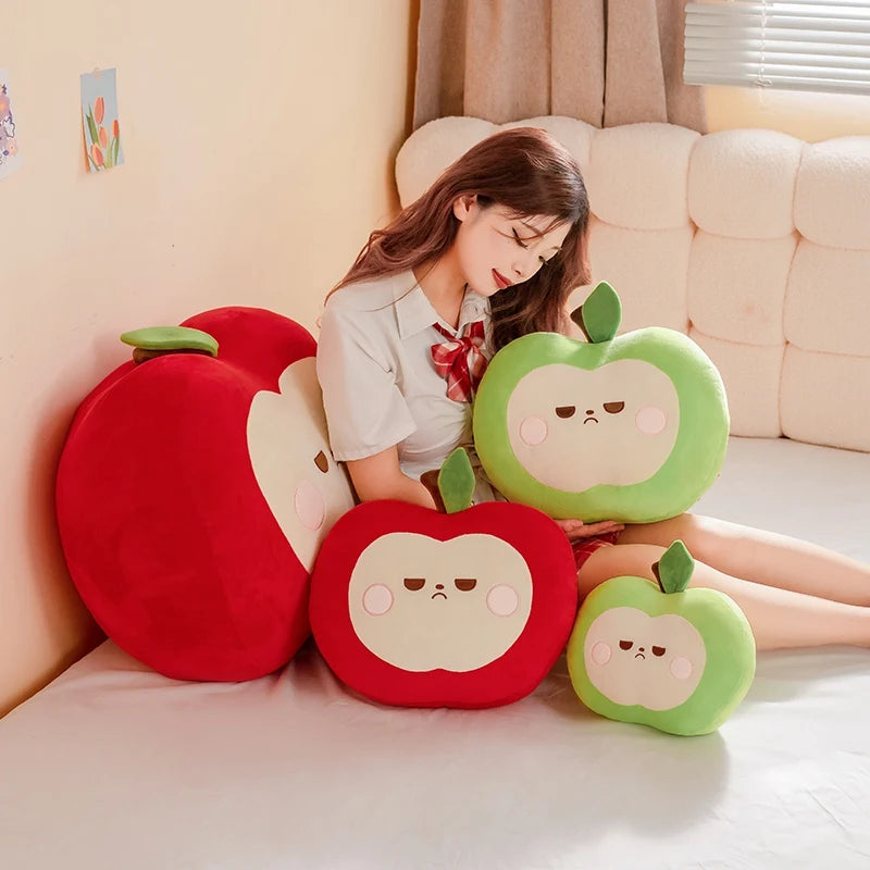 Woman sitting on a couch with kawaii apple-shaped cushions