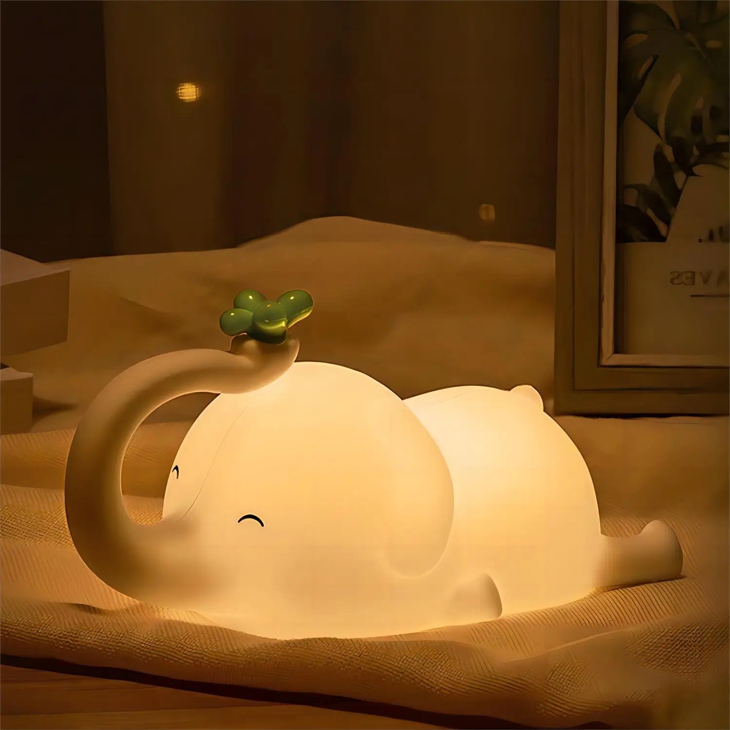 Cute elephant-shaped kawaii night light on a soft surface with a warm glow