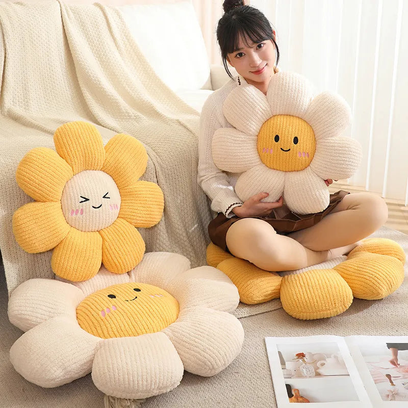 Woman sitting on a couch holding a large flower-shaped kawaii pillow with a smiling face, surrounded by similar pillows.