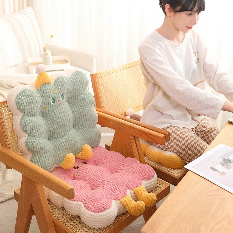 Person sitting on a chair with a colorful kawaii cushion featuring cartoon characters.
