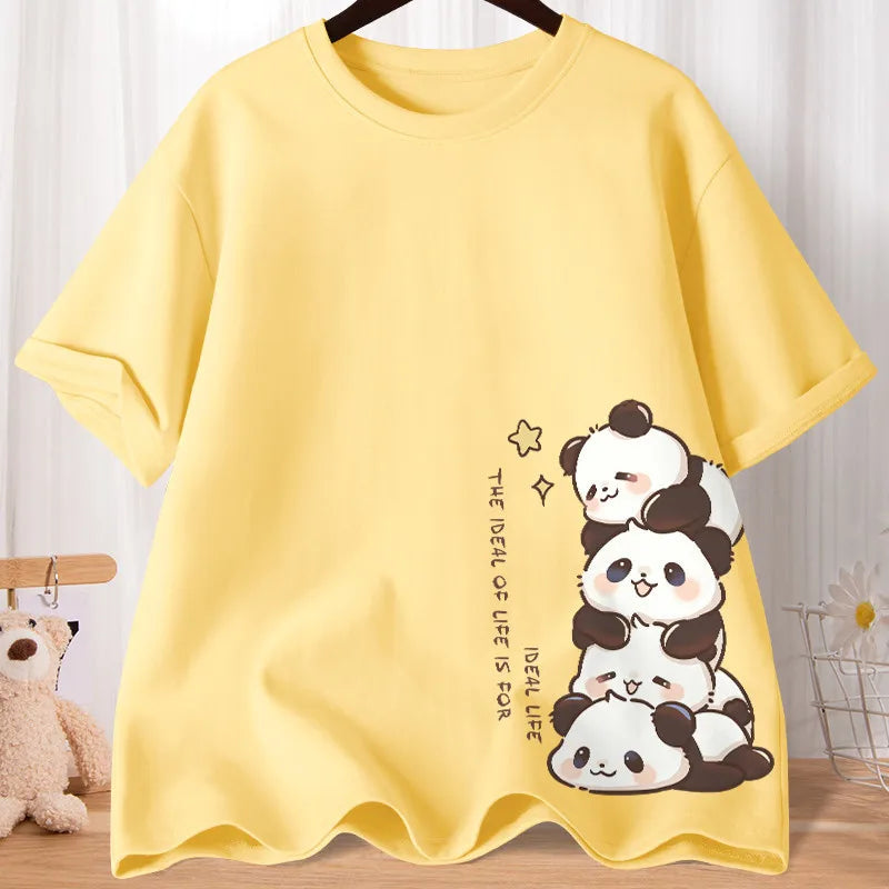 Yellow t-shirt with kawaii panda design on a wooden surface