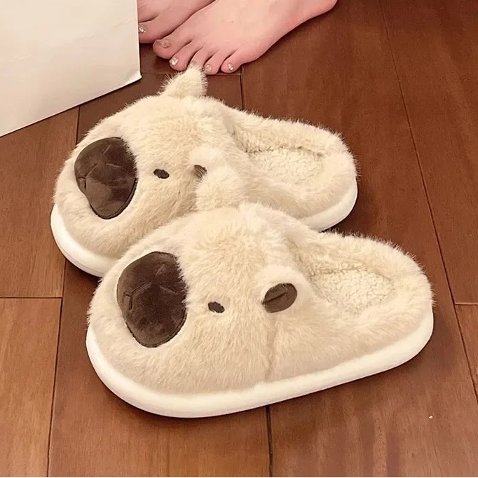 Pair of white kawaii slippers with brown accents on a wooden floor.